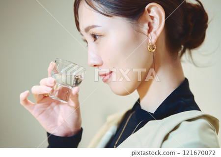 A woman tasting sake. Photo courtesy of Imayotsukasa Sake Brewery. 121670072