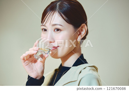 A woman tasting sake. Photo courtesy of Imayotsukasa Sake Brewery. 121670086