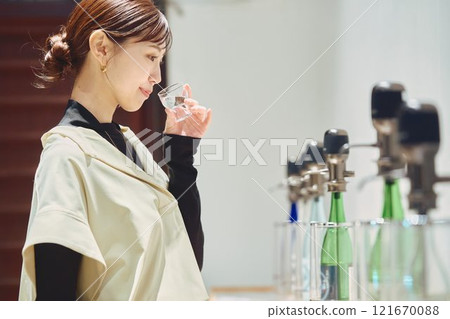 一位女士正在品嚐酒。 121670088