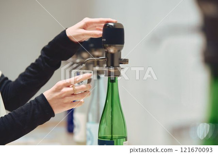A woman tasting sake. Photo courtesy of Imayotsukasa Sake Brewery. 121670093
