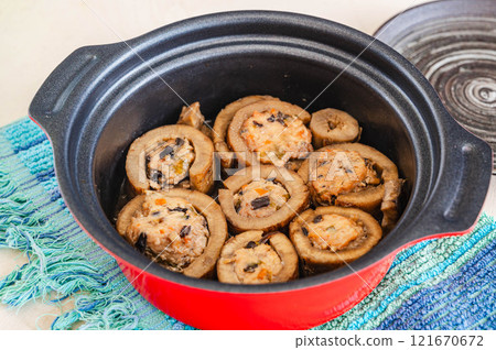 Burdock root stuffed with meat cooked in a pot Burdock root stuffed with meat cooked in a pot 121670672