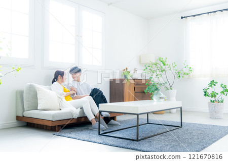 A young couple relaxing in the living room A young couple relaxing in the living room 121670816