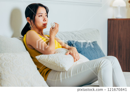 Young woman watching TV at night 121670841