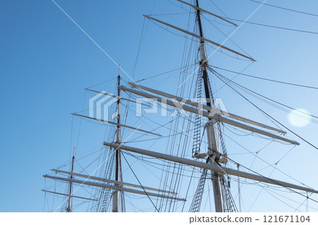 Sailing ship mast against the blue sky Sailing ship mast against the blue sky 121671104
