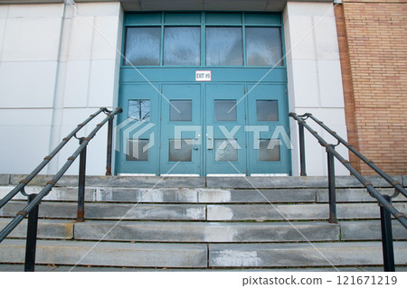Building entrance, staircase leading to the blue door 121671219