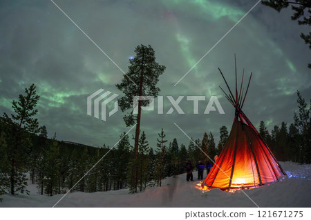 Sami tent with Northern Lights in Lapland Inari Nellin Lake forest 121671275