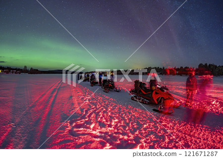 Snowmobile expedition Aurora Northern Lights in Lapland Inari Nellin Lake forest 121671287
