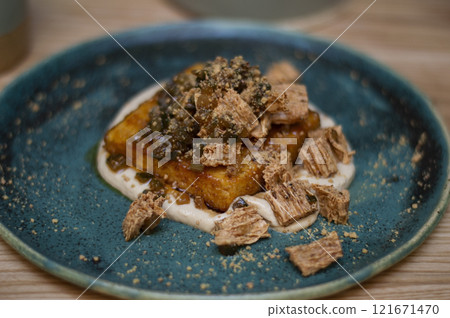 Baked tofu on a blue plate Baked tofu on a blue plate 121671470