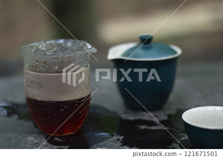 Tea ceremony set on a table in a forest Tea ceremony set on a table in a forest 121671501