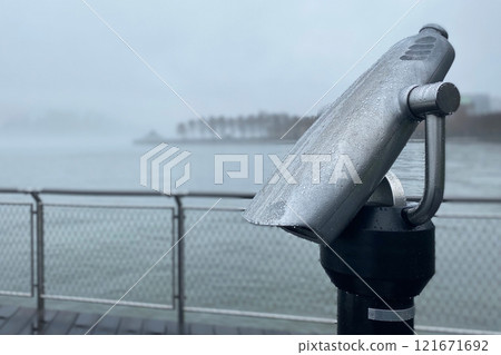 Coin operated binoculars in drops of rain, embankment in dense fog, foggy seafront, rainy weather Coin operated binoculars in drops of rain, embankment in dense fog, foggy seafront, rainy weather 121671692