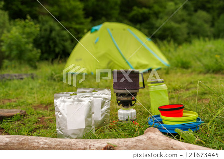 Cooking on a hike. Camping kitchen. Cooking freeze-dried food. Food in a camping camp. Kitchen and camping tent. Cooking on a hike. Camping kitchen. Cooking freeze-dried food. Food in a camping camp. Kitchen and camping tent. 121673445
