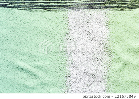 Green tennis court surface with white baseline in outdoor sports facility Green tennis court surface with white baseline in outdoor sports facility 121673849