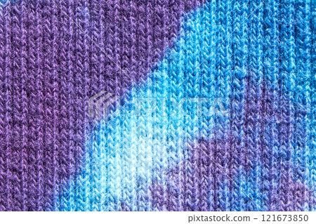 Close up of blue and purple tie dye knitted fabric texture pattern background 121673850