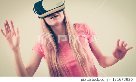 Girl wearing virtual reality goggles. 121673920