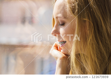 Girl on window enjoying sunny day 121673939