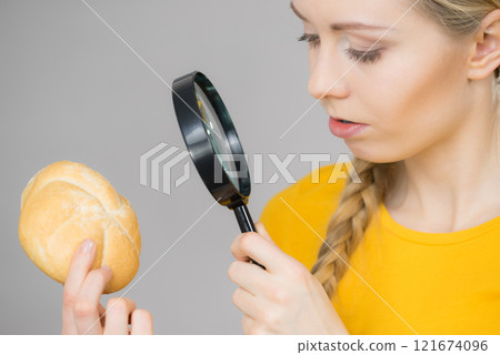 Bun bread roll and magnifying glass 121674096