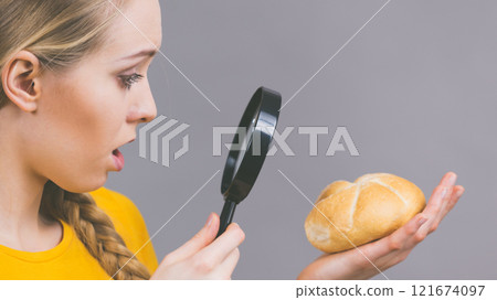 Shocked woman magnifying bun bread roll Shocked woman magnifying bun bread roll 121674097