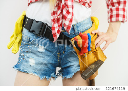 Woman wearing toolbelt Woman wearing toolbelt 121674119