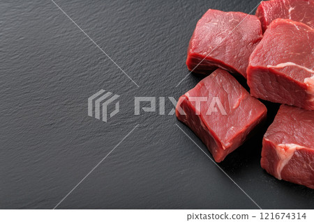 Raw beef meat on black slate background. Top view with copy space Raw beef meat on black slate background. Top view with copy space 121674314