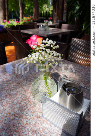 Bouquet of Flowers in Vase on a Table in a Street Cafe. Bouquet of Flowers in Vase on a Table in a Street Cafe. 121674336