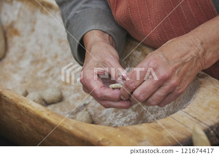 An elderly woman prepares food at a Viking festival in Denmark 121674417