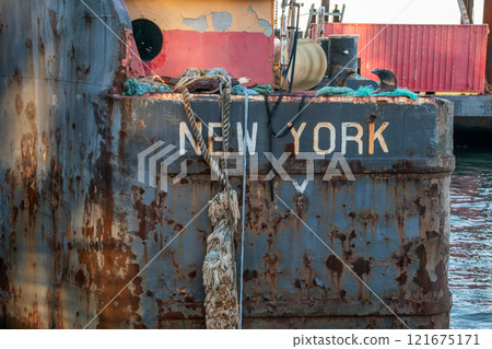 Old rusty barge ladder moored in New York City 121675171