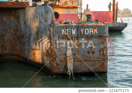 Old rusty barge ladder moored in New York City 121675173