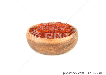 Wooden bowl with red salmon caviar isolated on white background. 121675309