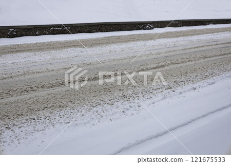 Traces of cars on white snow on the road. Snow fell on the road and no one cleans snow. 121675533