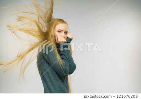 Sad girl with blowing hair Sad girl with blowing hair 121676209