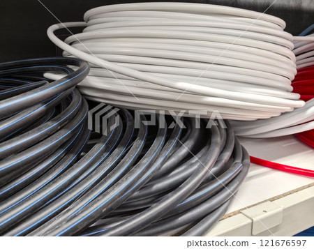 Coiled wires of various colors neatly arranged in storage space Coiled wires of various colors neatly arranged in storage space 121676597