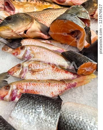 Fresh seafood display at a bustling market in the early morning hours Fresh seafood display at a bustling market in the early morning hours 121676627