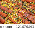 detail of a dish with carrots and corn 121676893