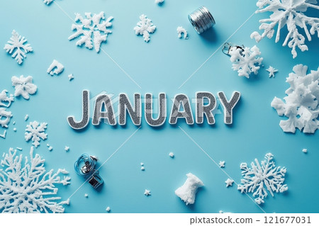 The word January is displayed prominently in shiny, glittery letters on a light blue surface. 121677031