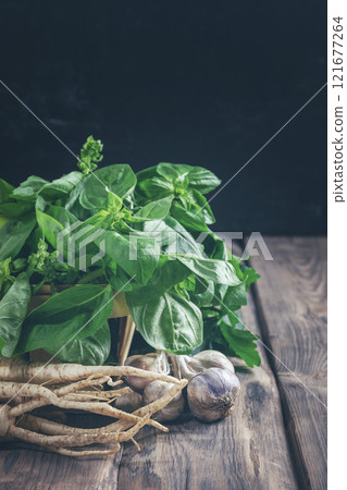 Basil, parsley, garlic. Fragrant herbs. Ingredient for vegetarian salads, soups, sauces. Fresh greens. Harvest. Spices. 121677264