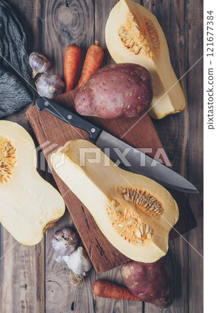 Baking food background. Pumpkins and seasonal spices for pumpkin or apple pie on a tabletop. Copy space. Autumn. Winter. 121677384