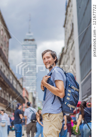 Male tourist exploring Latin American Tower in Mexico City. Iconic skyscraper, historic architecture, and urban exploration concept 121677722