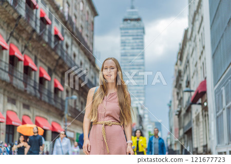 Female tourist exploring Latin American Tower in Mexico City. Iconic skyscraper, historic architecture, and urban exploration concept 121677723