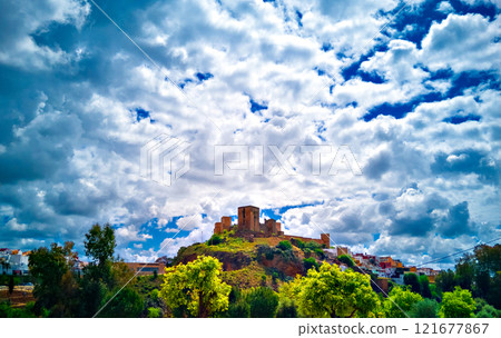 Views from the Parque de la Retama of the castle of Alcala de Guadaira in Seville, in blue sky and white clouds Views from the Parque de la Retama of the castle of Alcala de Guadaira in Seville, in blue sky and white clouds 121677867
