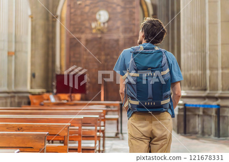 Man tourist exploring the grandeur of Catedral de Puebla, Mexico. Captivating architecture, cultural heritage, and a historic travel experience in one of Mexico's iconic landmarks 121678331