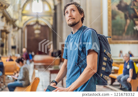 Man tourist exploring the grandeur of Catedral de Puebla, Mexico. Captivating architecture, cultural heritage, and a historic travel experience in one of Mexico's iconic landmarks Man tourist exploring the grandeur of Catedral de Puebla, Mexico. Captivating architecture, cultural heritage, and a historic travel experience in one of Mexico's iconic landmarks 121678332