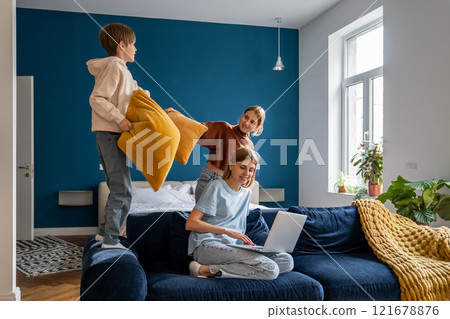 Young woman mother freelancer combining remote work with spending more time with family 121678876