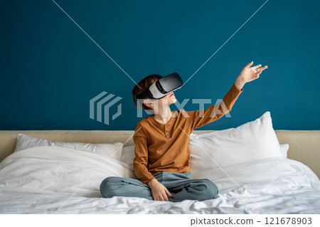 Inspired interested kid boy experience virtual reality goggles immersive in futuristic world at home 121678903