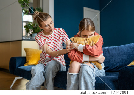 Loving mother supporting upset teen girl during difficult adolescence stage 121678911