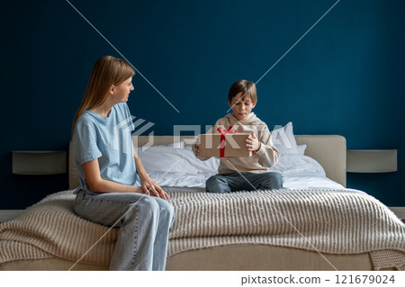 Loving parent mother congratulating child with birthday at home Loving parent mother congratulating child with birthday at home 121679024