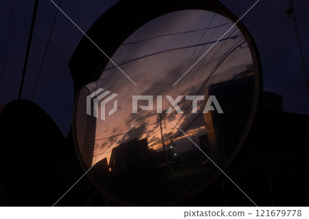 Sunset residential area reflected in a convex mirror 121679778