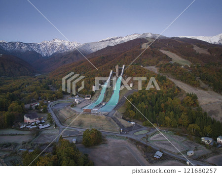 Three-tiered autumn foliage at Mount Goryu and Mount Happo-o before sunrise, Hakuba Village, Nagano Prefecture (aerial photography by drone) 121680257