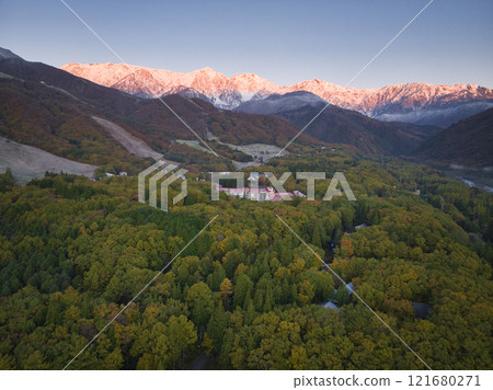 Beautiful morning glow of the Hakuba Sanzan mountains and three-tiered autumn foliage of Happo-one, Hakuba Village, Nagano Prefecture (aerial photography by drone) Beautiful morning glow of the Hakuba Sanzan mountains and three-tiered autumn foliage of Happo-one, Hakuba Village, Nagano Prefecture (aerial photography by drone) 121680271