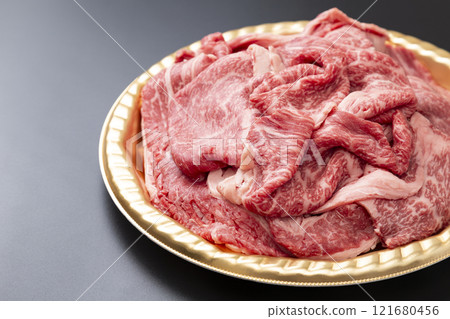 Beef shoulder loin for sukiyaki on a black background Beef shoulder loin for sukiyaki on a black background 121680456