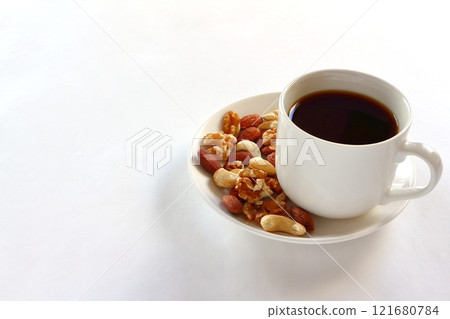 Coffee and mixed nuts on white background Coffee and mixed nuts on white background 121680784